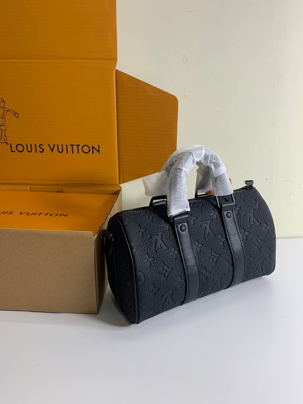 Louis Vuitton dark monogram handbag with two top handles and buttoned front
