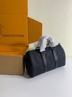 Louis Vuitton dark monogram handbag with two top handles and buttoned front
