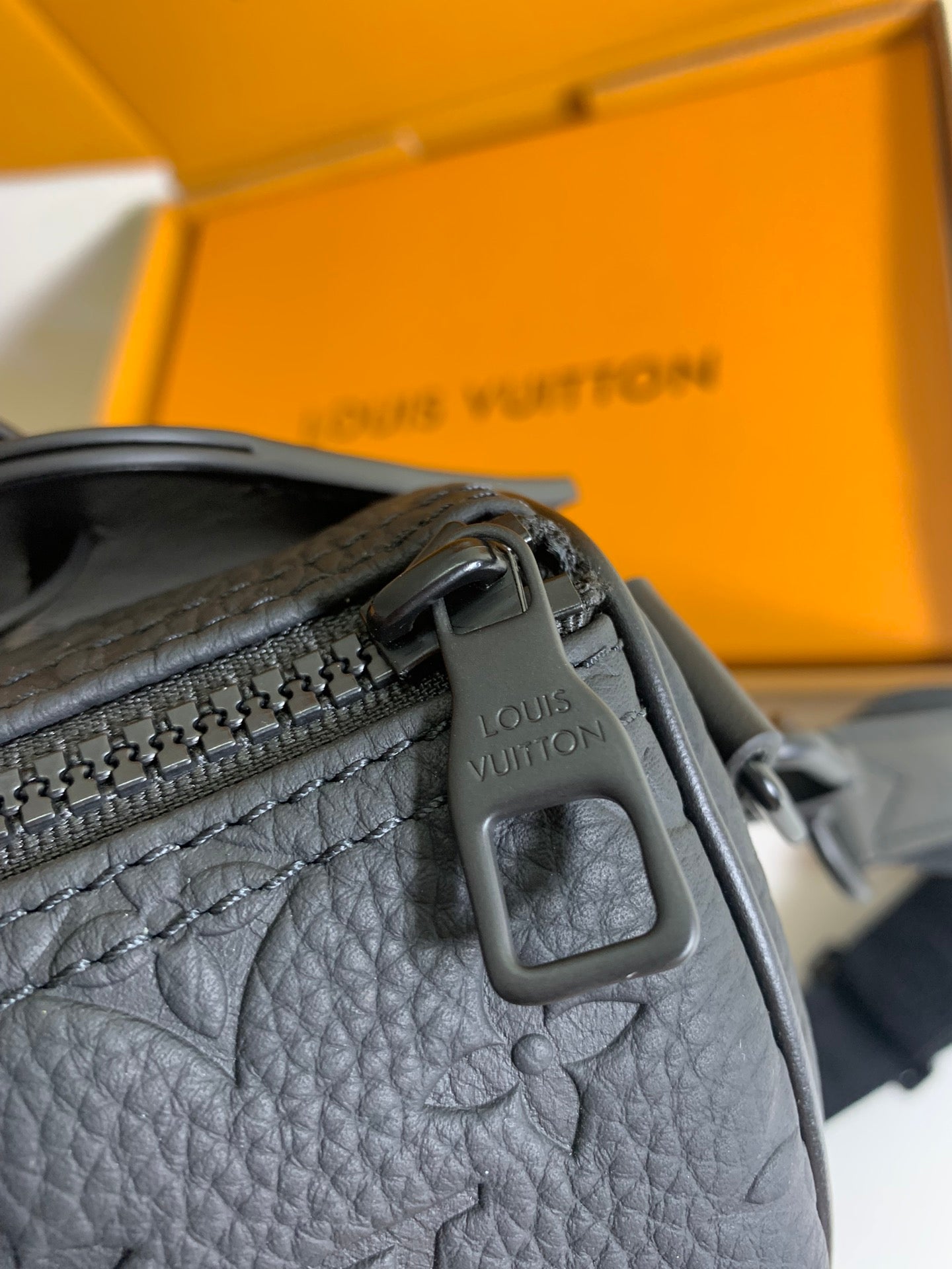 Louis Vuitton bag top strap with engraved Louis Vuitton mark on dark leather
