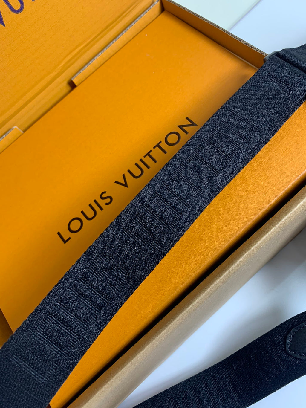 Louis Vuitton dark jacquard shoulder strap with repeating logo lettering