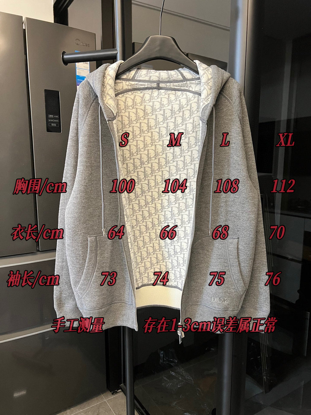 Gray heather zip-up hoodie on hanger with hood and front zipper; size markings shown