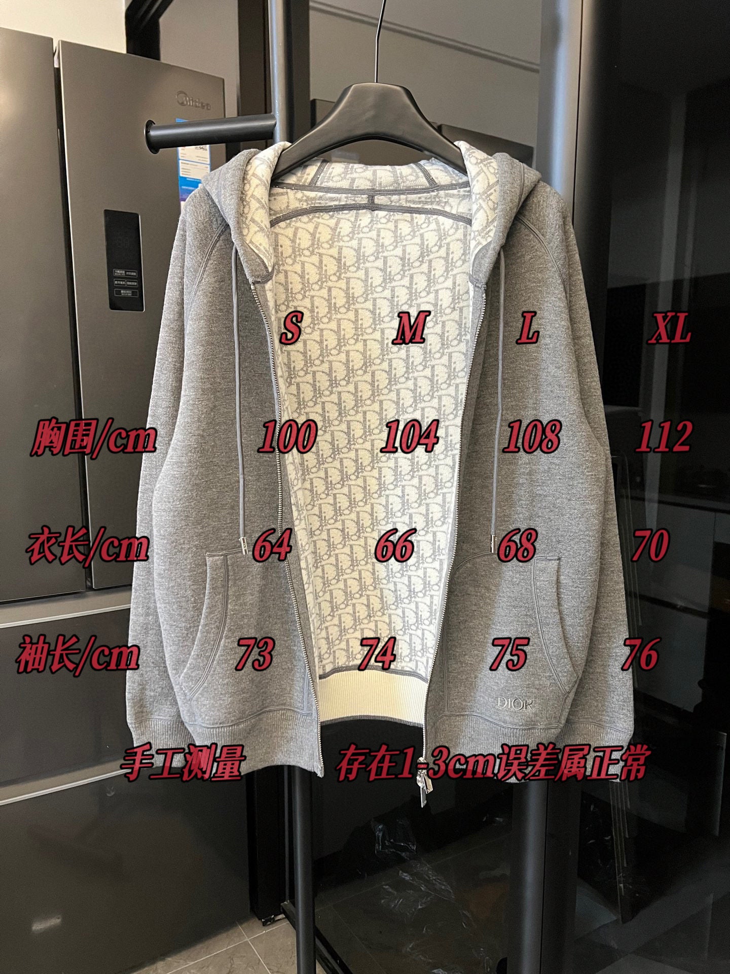 Gray heather zip-up hoodie on hanger with hood and front zipper; size markings shown