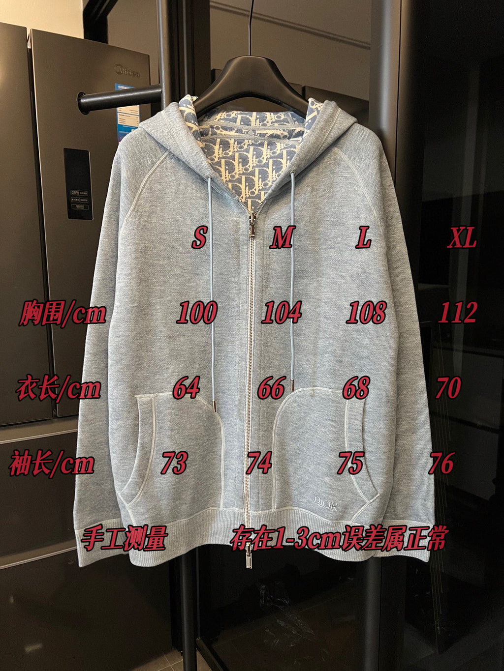 Light gray zip-up hoodie with hood and full front zipper on hanger