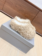 Beige faux-fur slide sandal with white insole, side view