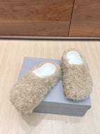 Beige faux-fur slide sandals with white insoles, close angle