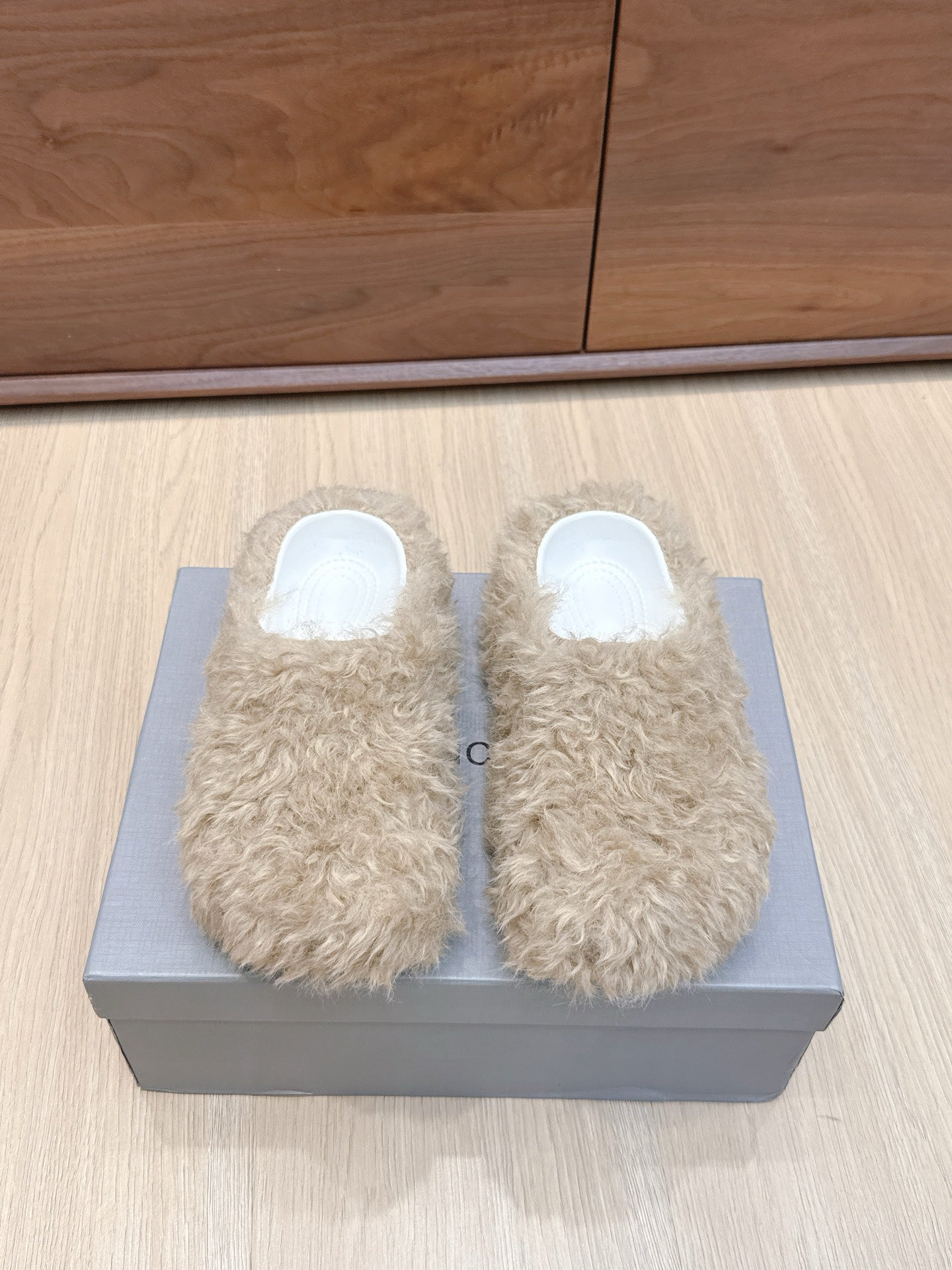Beige faux-fur slide sandals with white open-toe interior