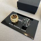Chrome accessories rings on polishing cloth card, gold crown-style ring and silver tone ring