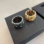Chrome accessories two rings on black display card, gold and black with green accents
