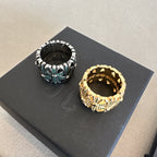 Chrome accessories pair of rings on black card, silver tone with green stones and gold ring