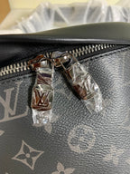 Black monogram belt bag close-up of zipper pull and metal hardware