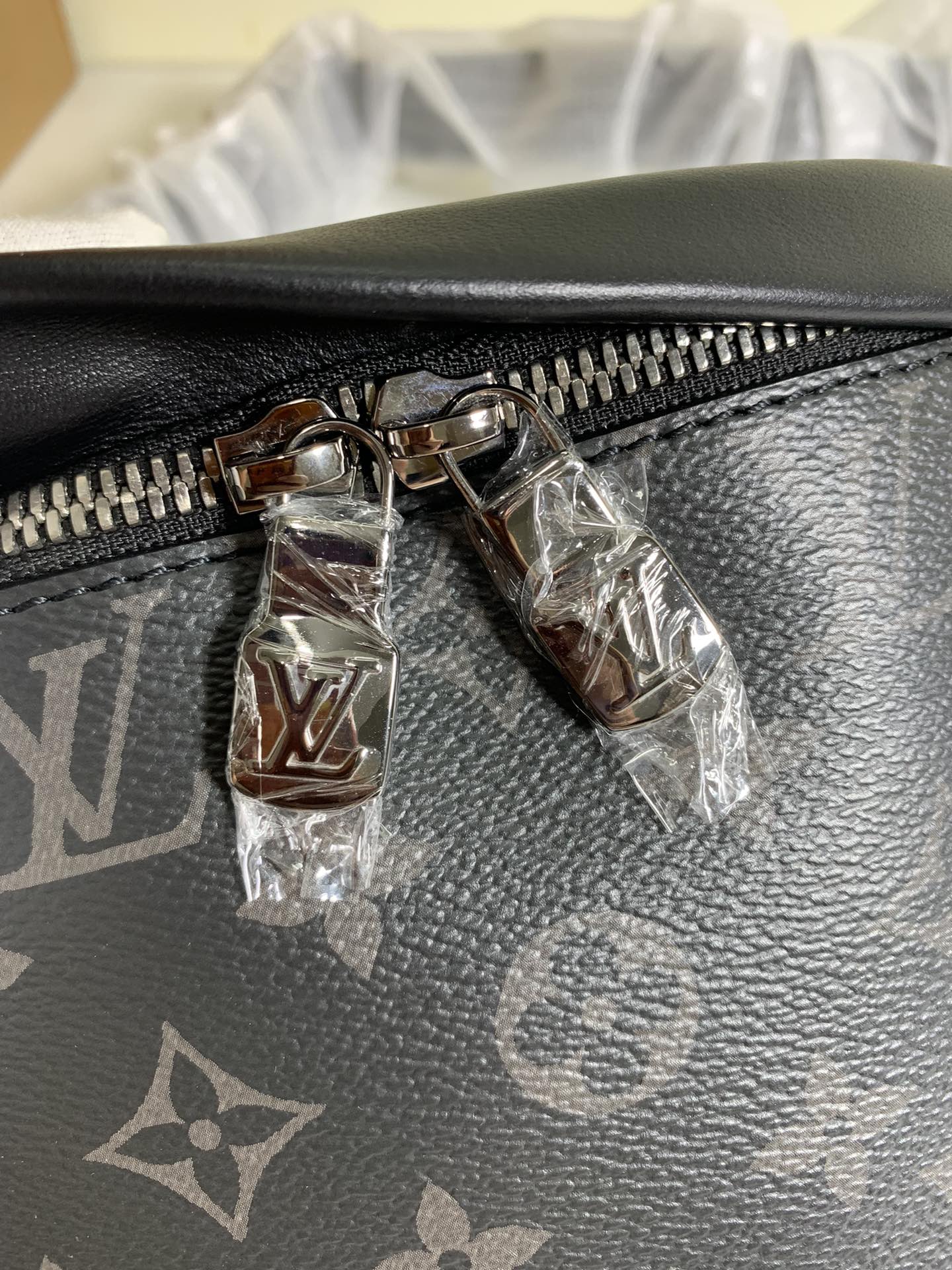 Black monogram belt bag close-up of zipper pull and metal hardware