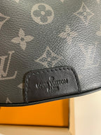 Black monogram belt bag with stitched brand logo patch on front