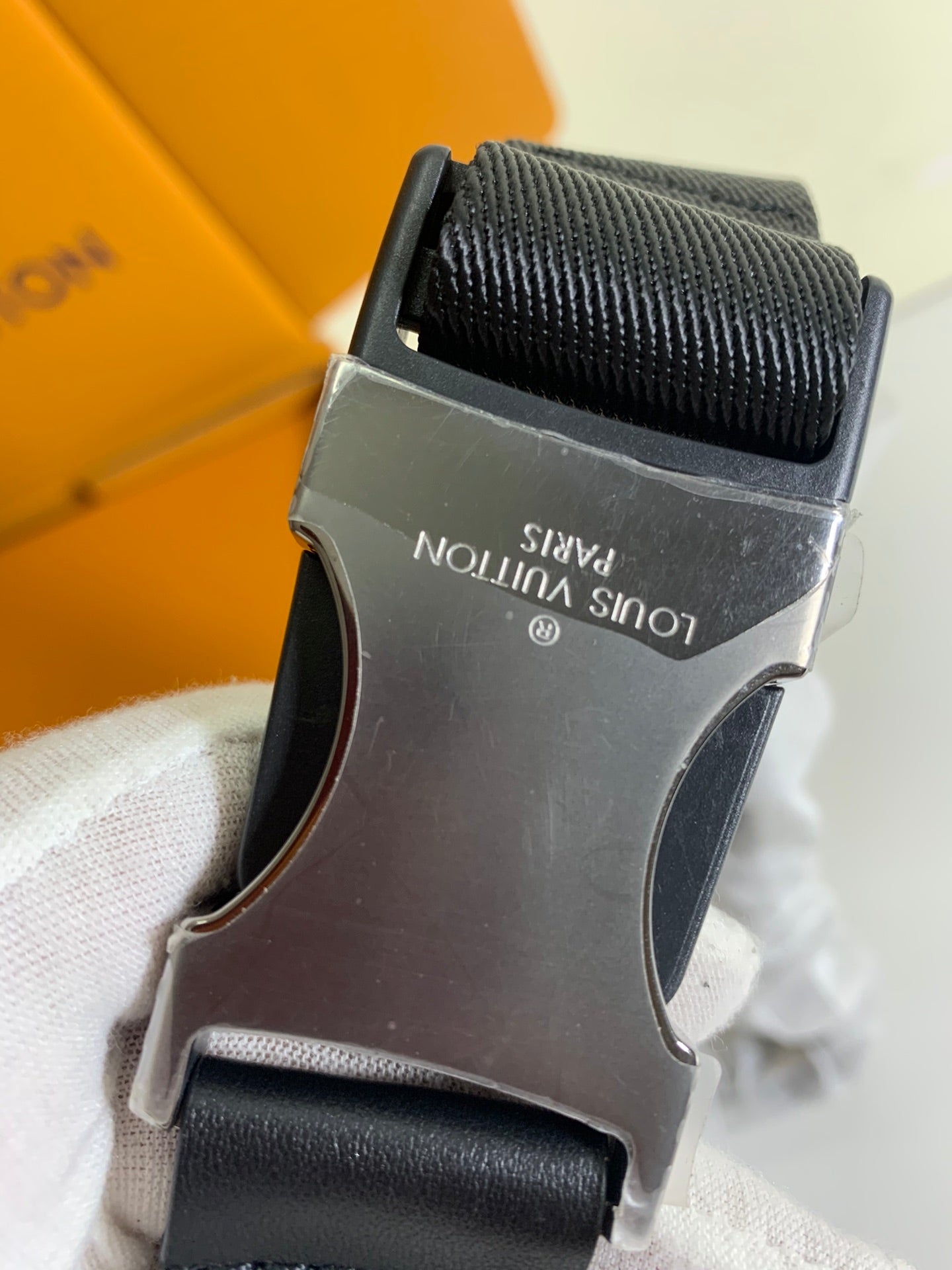 Black leather belt bag strap buckle with metal clasp and woven texture
