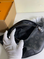 Black monogram belt bag open interior with zipper and leather logo patch