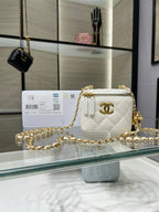 Quilted mini crossbody bag in white with gold chain and CC logo, zip top.