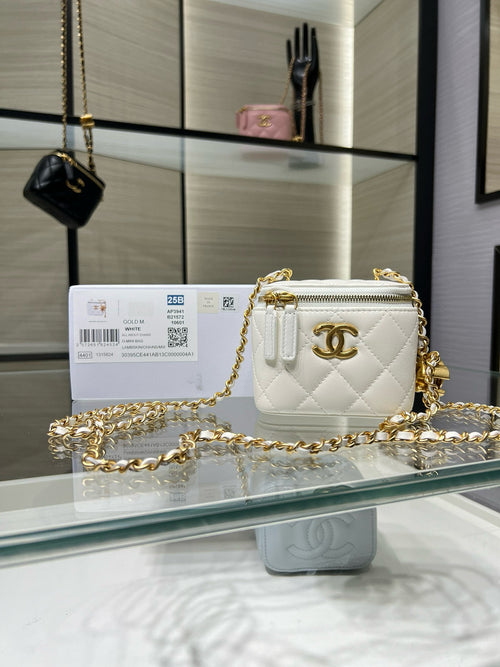 Quilted mini crossbody bag in white with gold chain and CC logo, zip top.