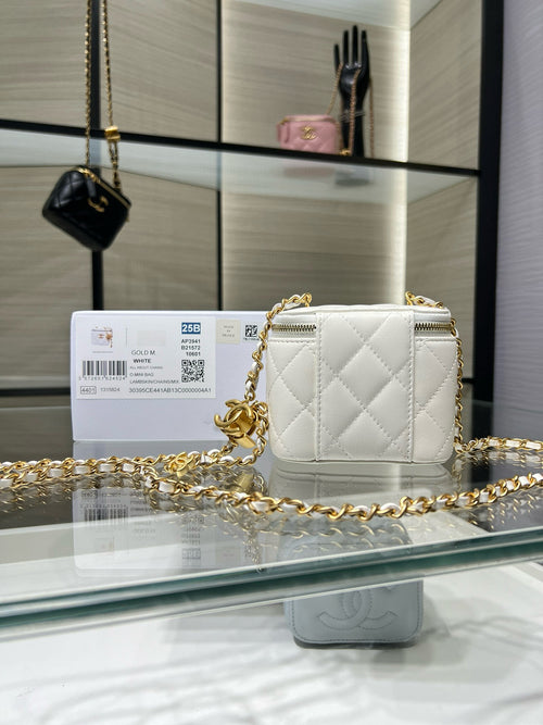 Quilted mini crossbody bag in white with gold chain and gold CC emblem, zip top.