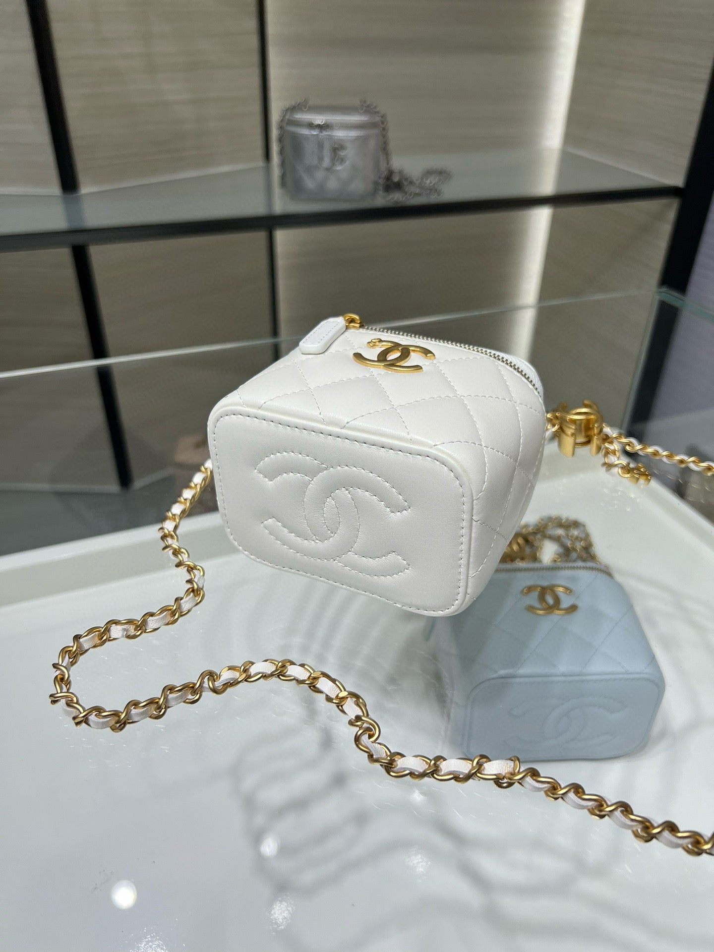 White quilted mini bag with gold-tone CC logo patch and gold chain strap
