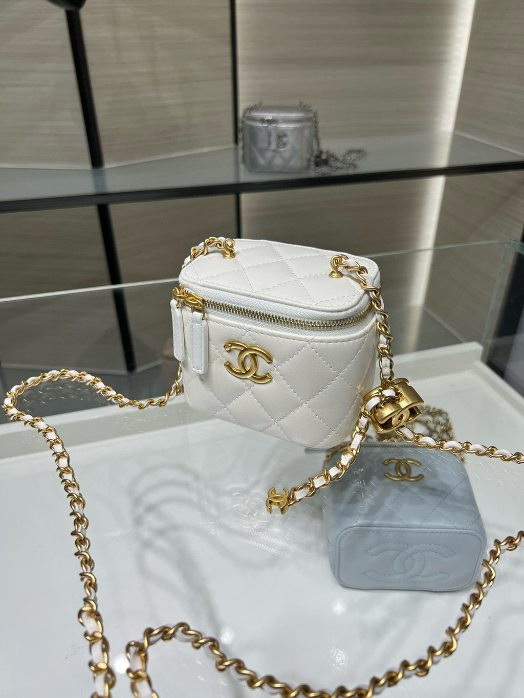 White quilted mini bag with gold-tone CC emblem, top zip, long gold chain strap