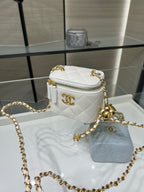 White quilted mini bag with gold-tone CC emblem, top zip, long gold chain strap