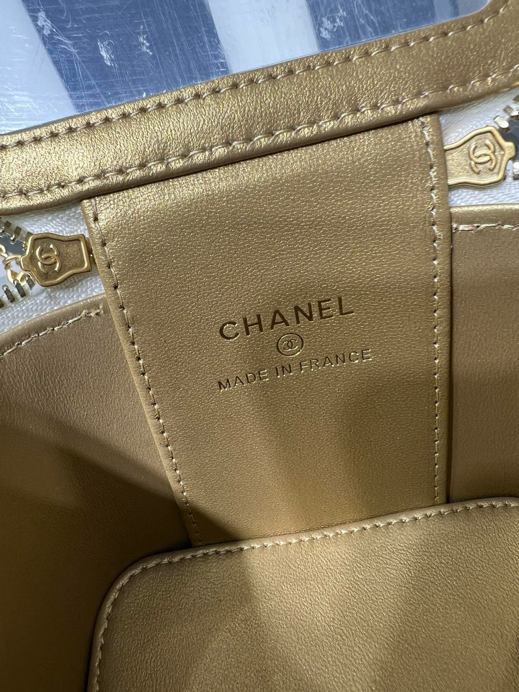 Gold leather bag label with CHANEL and MADE IN FRANCE text, stitched border