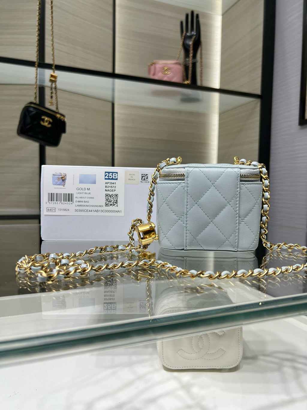 Chanel light blue quilted mini bag with gold chain shoulder strap and zipper