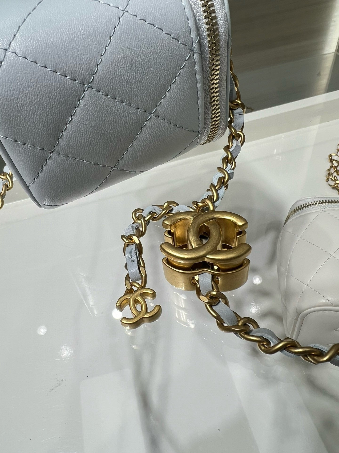 Chanel light blue quilted mini bag close-up of gold chain and clasp hardware