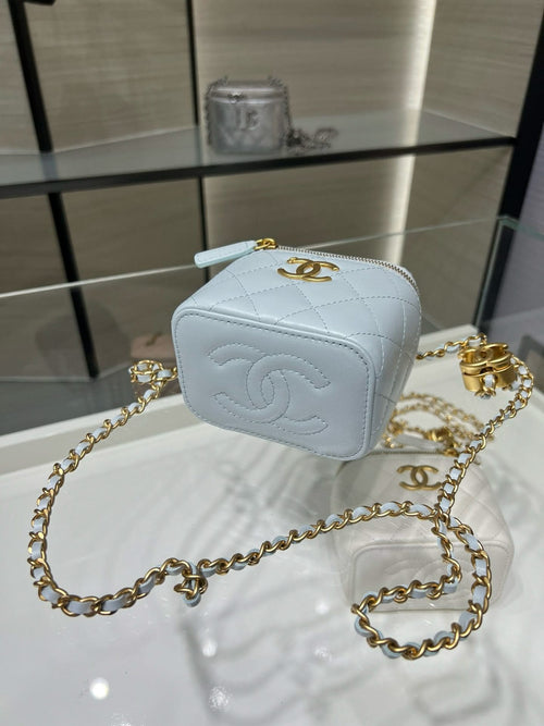 Light blue Chanel crossbody mini bag with quilted texture, gold chain, zipper