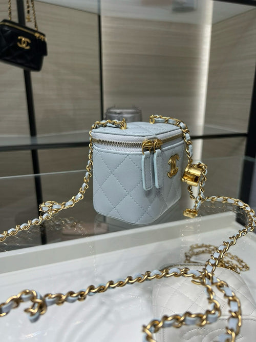 Light blue quilted Chanel mini bag with gold chain strap and top zipper