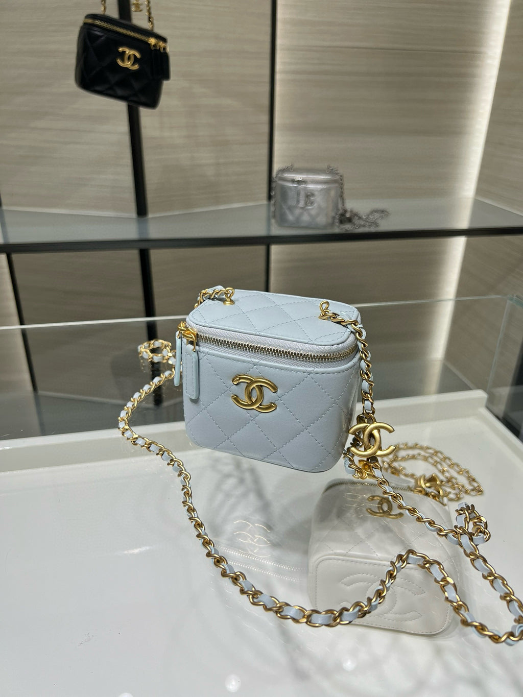 Chanel light blue quilted mini bag with gold chain shoulder strap and zipper