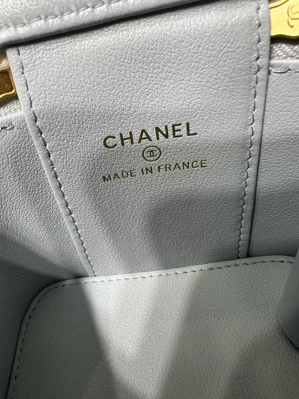 Light blue Chanel bag label reading CHANEL and MADE IN FRANCE
