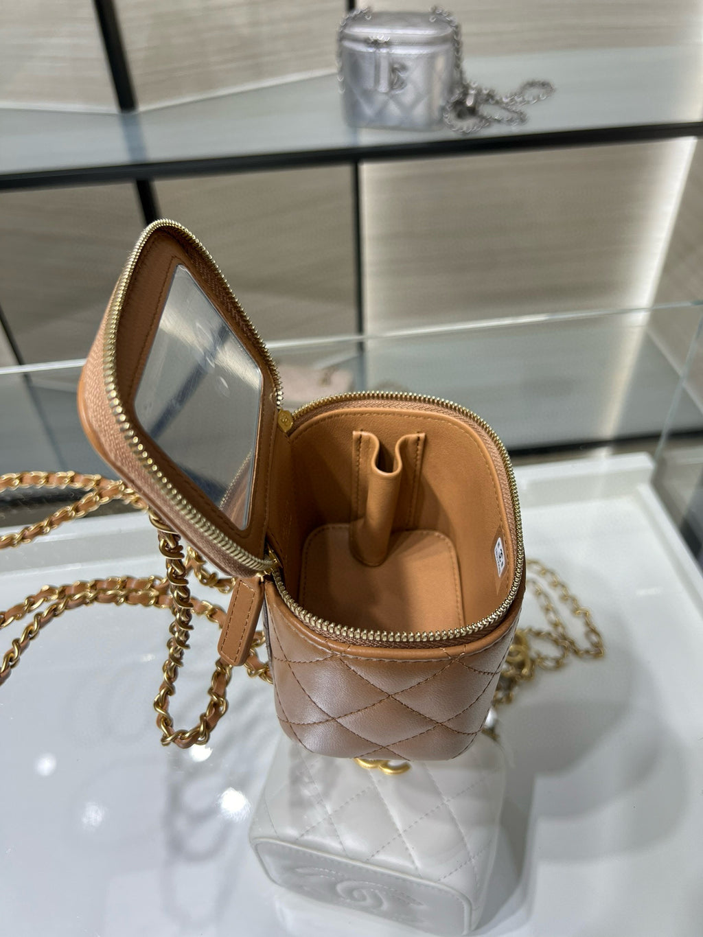 Mini quilted crossbody bag, beige exterior with open top and gold clasp
