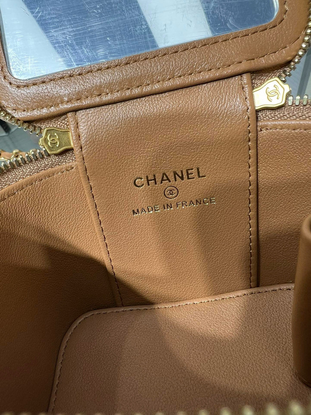 Mini bag interior tag, brown quilted leather with CHANEL and MADE IN FRANCE label