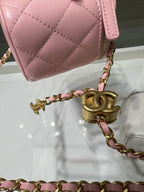 Close-up of pink quilted mini bag side with gold chain and lobster clasp.