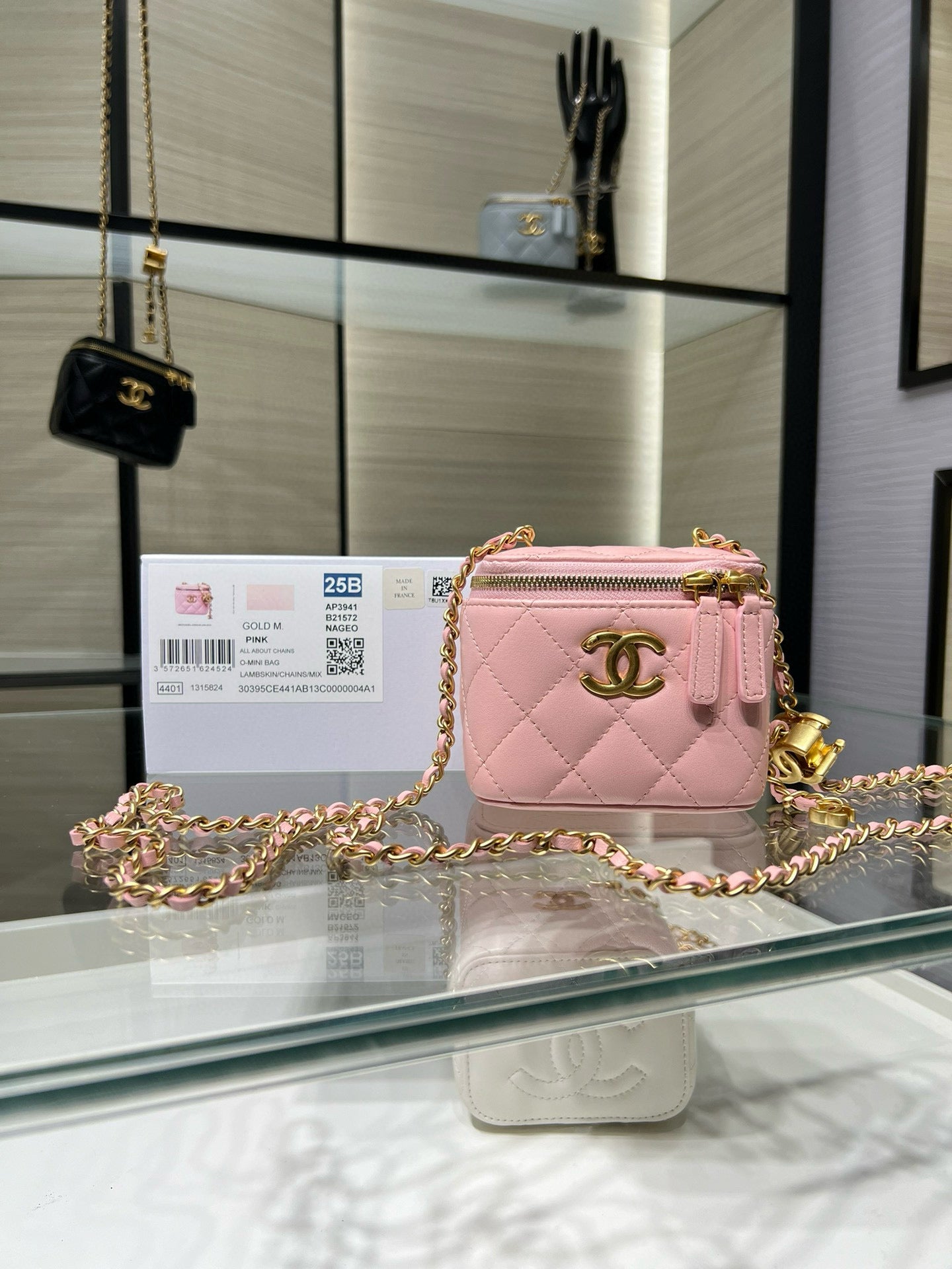Pink quilted mini bag with gold chain strap and top zipper, front CC logo charm.