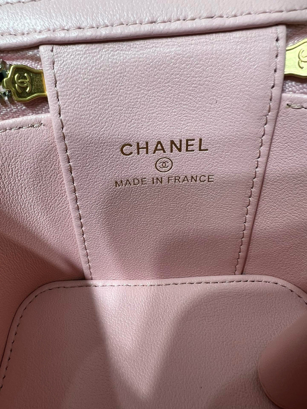 Pink leather bag label reading “CHANEL” and “MADE IN FRANCE” on interior panel.