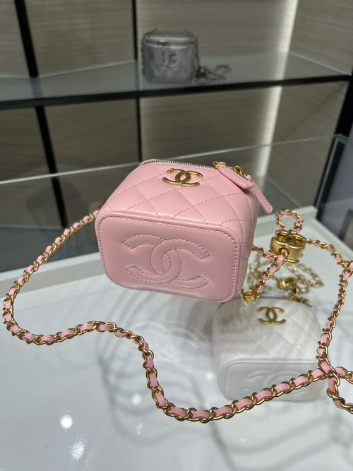 Pink Chanel mini bag with diamond quilting, gold CC logo, and chain strap.