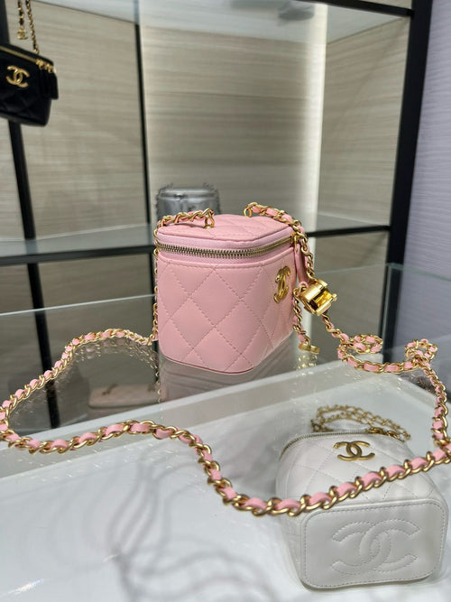Pink Chanel quilted mini bag with gold chain strap and top zipper.