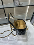 Chanel mini bag with open top view, black quilted leather and gold zipper trim