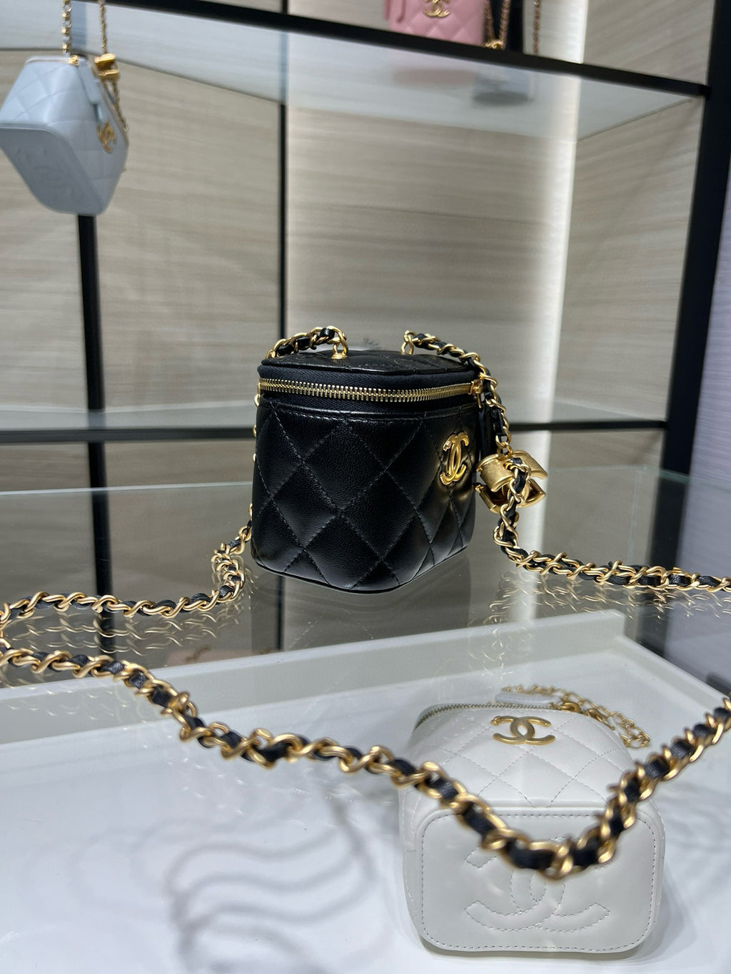 Chanel mini crossbody bag, black quilted leather with gold chain and zip top