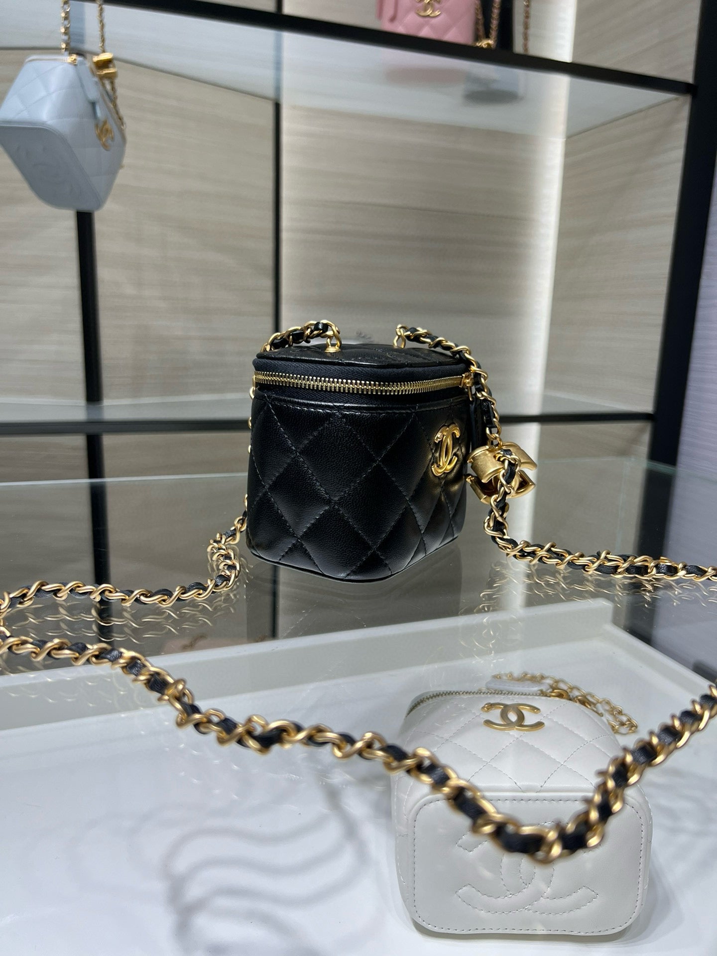 Chanel mini crossbody bag, black quilted leather with gold chain and zip top