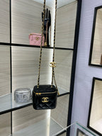 Chanel mini crossbody bag, black quilted leather with gold chain strap and CC emblem