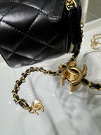 Chanel bag close-up: black quilted leather with gold chain and logo hardware
