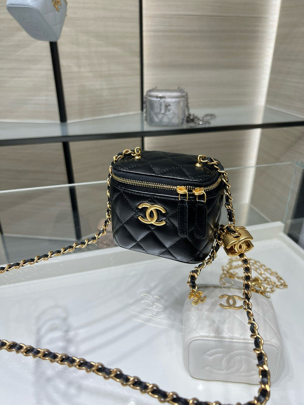 Chanel mini crossbody bag, black quilted leather with gold logo and zip closure