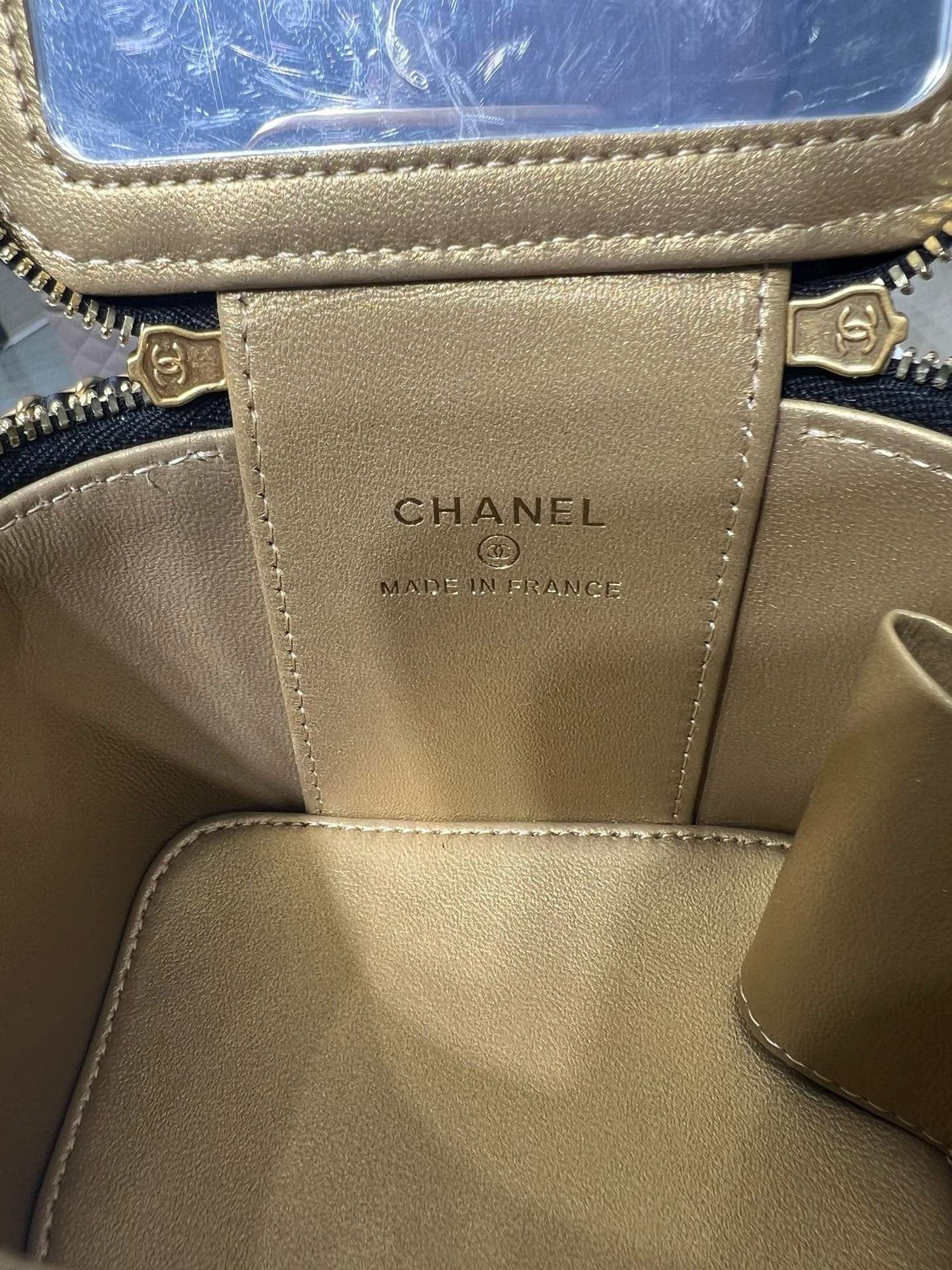 Chanel interior label on beige leather lining, with gold zip and stitched edges