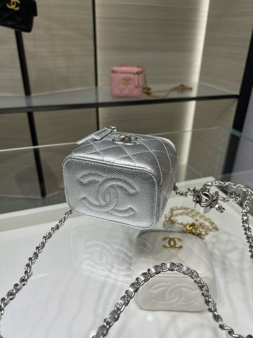Silver embossed mini vanity bag with chain strap, textured front and zipper top