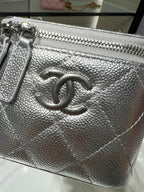 Silver textured clutch pouch with large CC clasp and metal zipper, chain shoulder