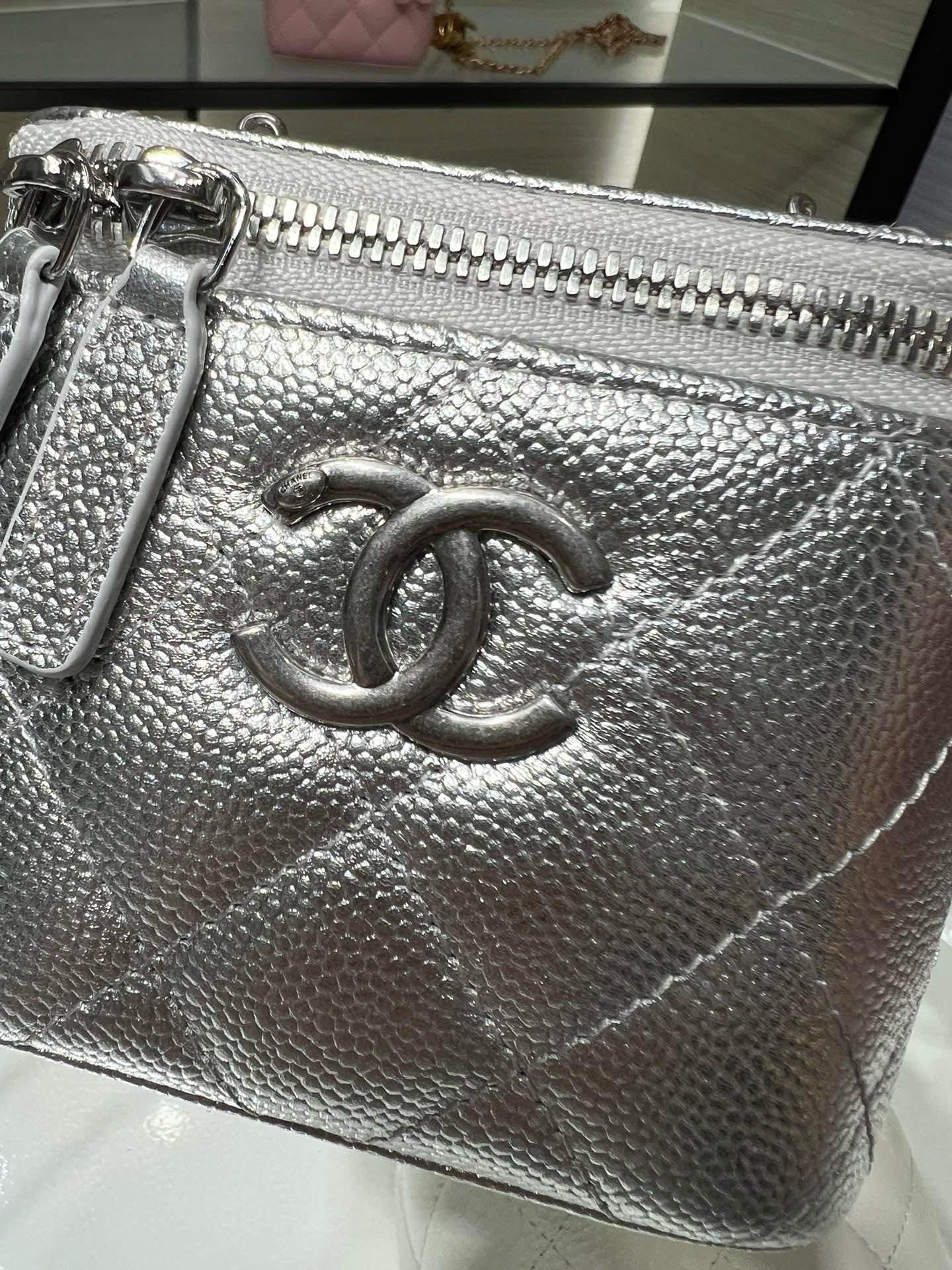 Silver textured clutch pouch with large CC clasp and metal zipper, chain shoulder