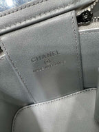 Silver leather bag interior label: CHANEL, Made in France, on stitched pocket