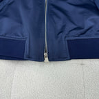 Dark blue bomber jacket with front zip and side zip pockets plus ribbed hem